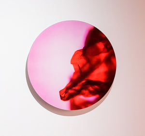You Tell Me No. 4 utilizes the fluid texture of light, specifically bringing the color of red that materializes over a pink background with a soft circular highlight at the center, the work is circularly shaped.